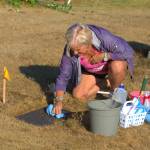 A volunteer works to clean the headstone of a World War 1 veteran. Elisha Meyer/Kitsap News Group Photos