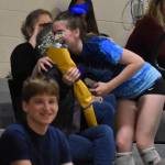 Sophia Baugh ran up to give flowers during introductions of the varsity game.