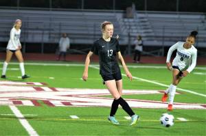 Sophomore Marisa Brown passes the ball to a teammate just behind midfield. Elisha Meyer/Kitsap News Group