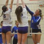 Emilia Linden (5) of Fife spikes the ball over the outstretched arms of Vikings Mary Allen (6) and Sophia Baugh (3).