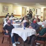 Veterans, friends and family watch the ceremony at Brookdale Montclair senior living facility in Poulsbo Nov. 11.