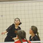 Senior Grace Mosco (5) sends a spike over the net for Kingston.