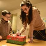 Sam and Adriaana Garrard prepare a shoebox for shipping.