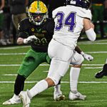 Carter Dungy runs the ball through the Lynden defense for a first down. Nicholas Zeller-Singh/Kitsap News Group Photos