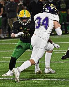 Carter Dungy runs the ball through the Lynden defense for a first down. Nicholas Zeller-Singh/Kitsap News Group Photos