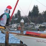 Boats in the Port Orchard Marina display Christmas decorations such as this penguin standing on the edge of the boat.