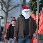 A casually-dressed Santa Claus walks to City Hall.