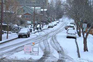 Signs point cars away from the major uphill roads and toward designated snow routes in downtown Port Orchard. Elisha Meyer/Kitsap News Group Photos