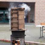 Sweet rice is steamed in wooden boxes over an open fire as it has been done for nearly a thousand years.