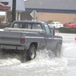 A resident drives a truck through the floodwaters in downtown Port Orchard despite road blocks warning otherwise.