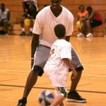 Former NBA player Marvin Williams plays with a youngster during one of his basketball camps in his hometown of Bremerton. File Photos