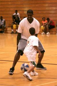 Former NBA player Marvin Williams plays with a youngster during one of his basketball camps in his hometown of Bremerton. File Photos