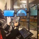 Kingston High School senior Kahn Kalii uses the flight simulator in the school library during lunch. It has a cockpit seat with all the controls and functions of a flying vessel. Tyler Shuey/Kitsap News Group Photos