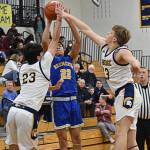 Spartans Cooper Benjamin and Caleb Durrance block Knight Isaiah Cadengos shot attempt. Nicholas Zeller-Singh/Kitsap News Group Photos
