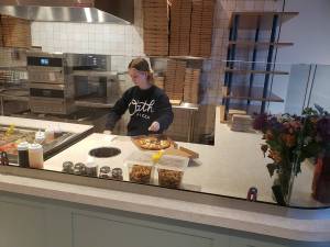 Emily Langford, daughter of owners Brad and Jennifer, prepares a pizza at the newly opened Oath Pizza in Poulsbo. Tyler Shuey/Kitsap News Group Photos