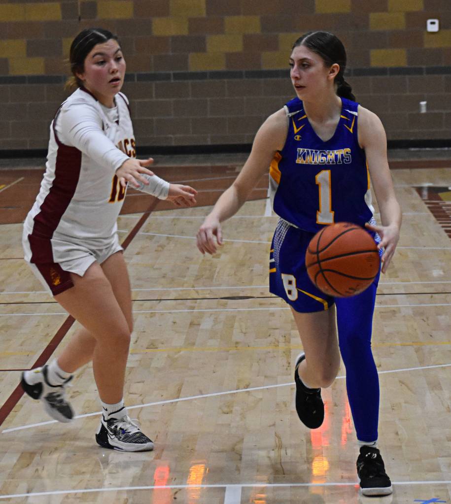 McKaela Robison dribbles around Jayla Moon for the shot.