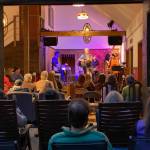 A performance inside the barn with guests watching.