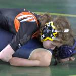 Angel Cartagena looks to pin her opponent.