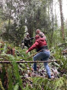 Authorities lead one of the suspects out of the woods who stole a U-Haul van. KCSO Courtesy Photos