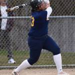 Spartan Sofia Peato smashes the ball to the fence.