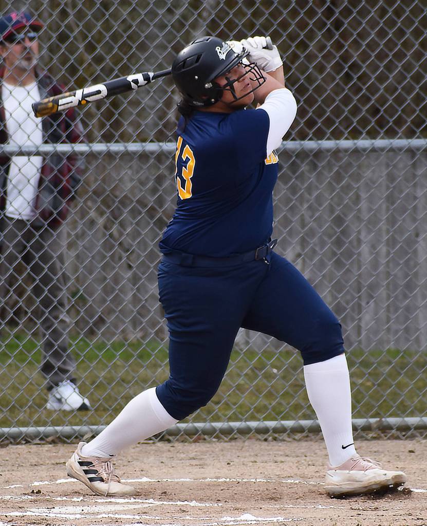 Spartan Sofia Peato smashes the ball to the fence.