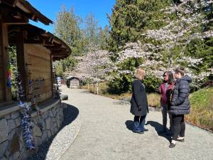 Chris Mueller, Ellen Sato Faust and Chantelle Lusebrink listen to the new audio tour, which features excerpts from recorded interviews of survivors sharing first-hand accounts of the exclusion. Nancy Treder/Kitsap News Group