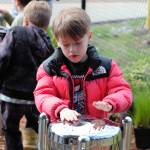An Olalla Elementary student plays a rhythm on the new Babel Drum in the sensory garden.