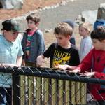 Three boys play the new handpipes in the Olalla Elementary sensory garden.