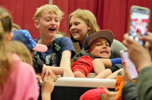 A group of students tries to remain chill while dipping their hands in a cooler of ice water. Elisha Meyer/Kitsap News Group Photos