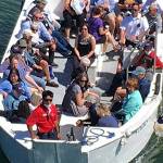 Cruise passengers return from Poulsbo to the ship aboard a tender boat.