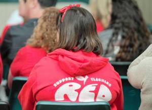 An audience member wearing red in support of teachers attends the special session of the South Kitsap School District board. Elisha Meyer/Kitsap News Group Photos