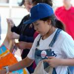 10-year-old Dakota packs some canned vegetables into plastic bags.