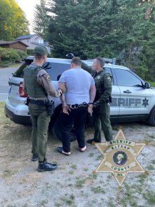 The suspect is arrested and led to a Kitsap County Sheriffs Office vehicle by law enforcement. KCSO courtesy photo
