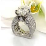 Left: Montana Sapphire cut in a kite shape with lavender, grey, and flashes of pink, including recycled gold and diamonds. Center: Callahans own wedding ring, re-done by the artist herself after the center gem was damaged. Right: Vivid Yellow Moissanite set in 14 k x1 White Gold and accented with 20 1 mm and 18 1.8 mm VS GH Diamonds in the band plus 2 1.5 mm in the 2 opposite corners of the Euro Shank.