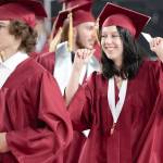 The party has already started for one dancing graduate as she and her class step toward their seats.