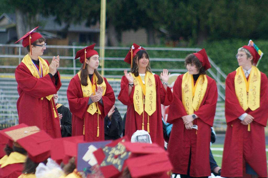 Valedictorians take the stage and receieve applause.