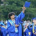 A Bremerton graduate finds a familiar face in the crowd, doing so with a little help from his phone. Elisha Meyer/Kitsap News Group Photos