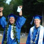 Olympic High School graduates make their way to their seats while receiving applause from the stands.