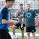 Coach Patrick Leonard barks at players during a practice drill.
