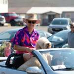 Mayor Rob Putaansuu rides with a furry friend in the Fathoms O Fun Grand Parade.