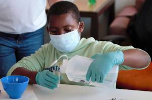 Zion works on the first steps toward making alginate, an impression-making material. Elisha Meyer/Kitsap News Group Photos