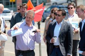 Mayor Rob Putaansuu (left) discusses the future site of Kitsap Bank headquarters and the Port Orchard Community Center on a walking tour toward the brownfield site with Casey Sixkiller (right) and other local and state leaders. Elisha Meyer/Kitsap News Group