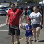 A family walks toward the stretch of vendors along the Port Orchard waterfront.