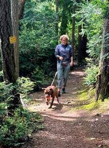 Molly Clark walks Tarkin around the forested trails on the shelter grounds. Mike De Felice/Kitsap News Group