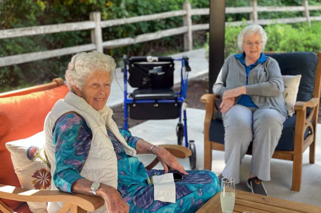 Two residents enjoying their afternoon in the Madrona house gazebo. Photo courtesy of Bainbridge Senior Living.