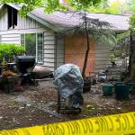 Caution tape surrounds a home on Sunrise Drive that caught fire June 29 and claimed the life of Charles J. Adolfson. Nancy Treder/Kitsap News Group