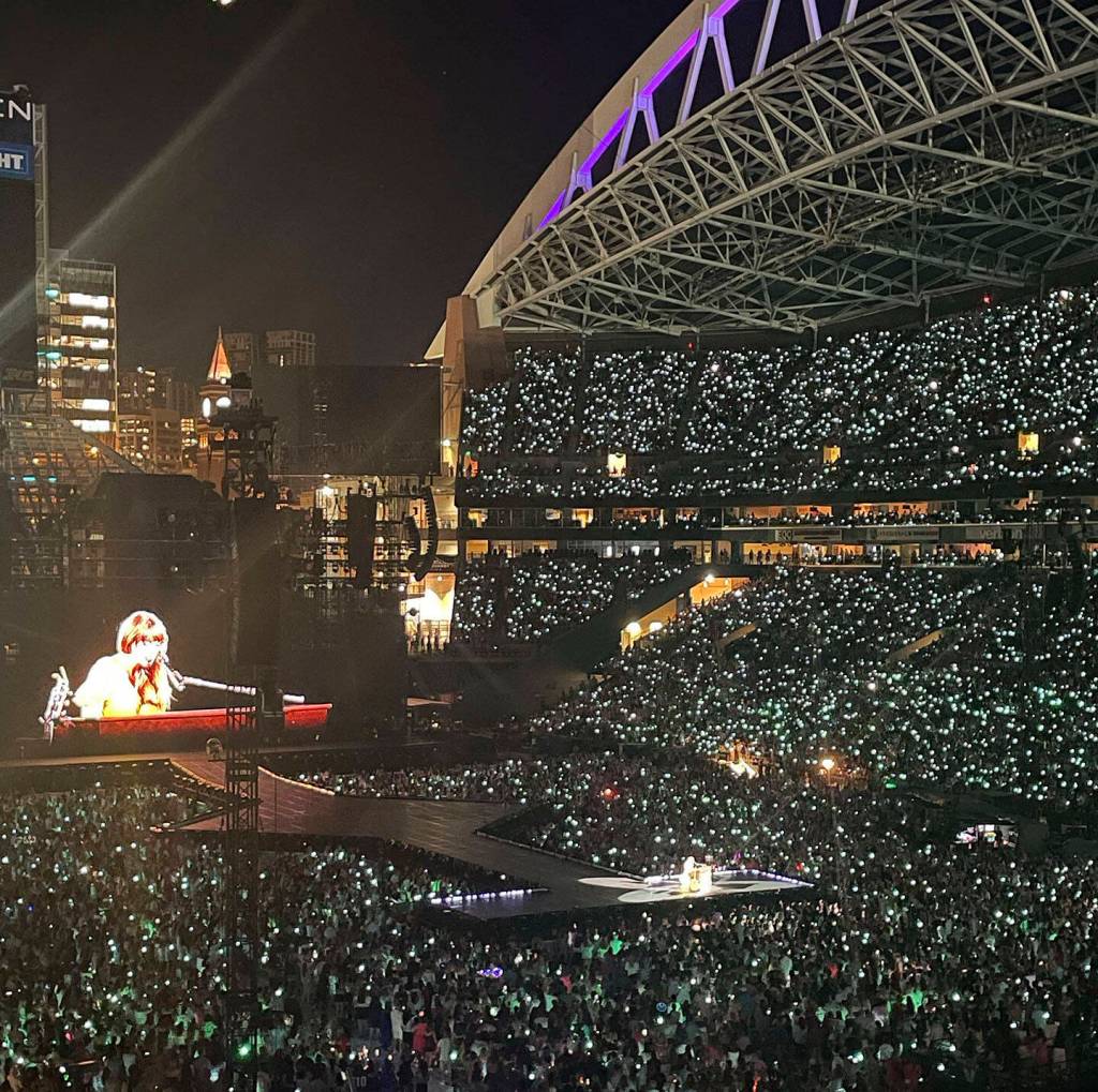 The concert lights up the stadium at night.