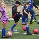 Sydney Leech and Taylor Keaty-Wallorich practice dribbling with Everton coaches. Nicholas Zeller-Singh/Kitsap News Group Photos