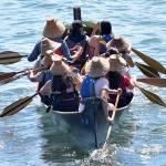 A canoe proceeds to the beach to come ashore on the Suquamish reservation.