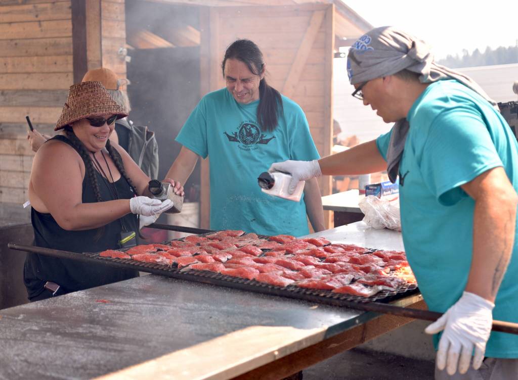 Cooks prepare salmon for the evening feast.